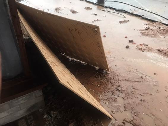 A broken wood planks on a wet floor

Description automatically generated with medium confidence