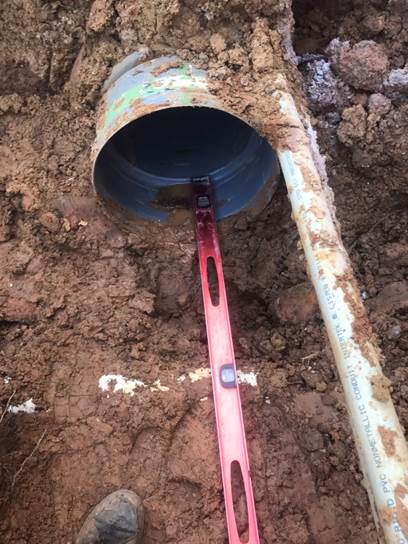 A pipe with a red tool

Description automatically generated